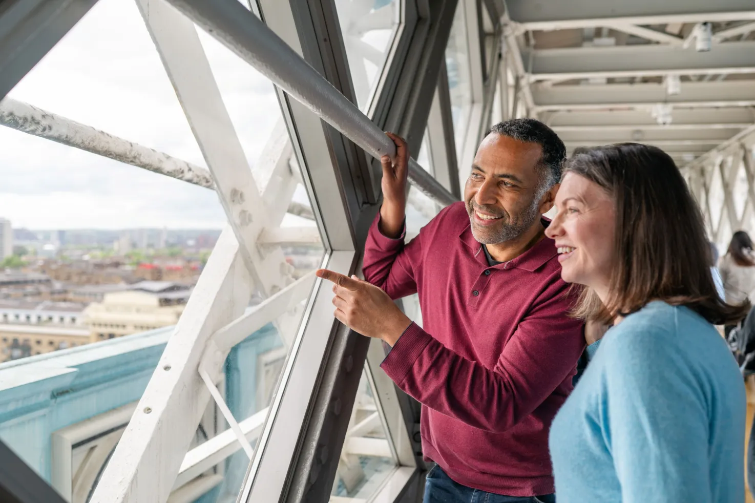 A man and a woman admiring the views on the Walkways of Tower Bridge