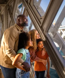 A family admiring the views from the Walkways at Tower Bridge