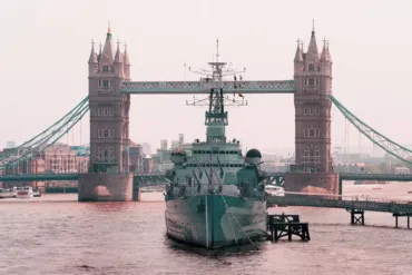 HMS Belfast moored in front of Tower Bridge.
