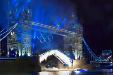 Floodlight and fireworks around Tower Bridge as it opens with the Olympic Rings placed on the front of the Bridge.