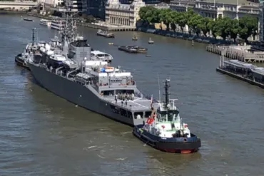 A large grey japanese warship on the River Thames