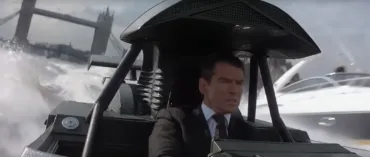 Pierce Brosnan as James Bond on a single seater speedboat with Tower Bridge in the background