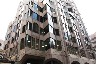 The Minister Court, a large building featuring numerous windows, showcasing a Neo-Gothic architecture style.