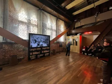 People watching a video on a guided tour