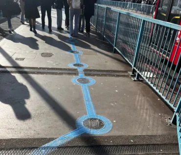 A blue painted line with plaques at regular intervals