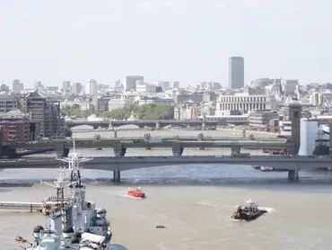 Aerial view of the River Thames featuring Southwark Bridge and London, Millennium and Blackfriars Bridges upstream.