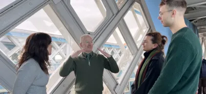 Deaf guide leading a guided tour in British Sign Language with guests in Tower Bridge