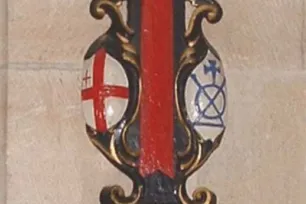 An ornate, ceremonial sword rest on a stone wall