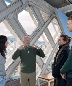 Deaf guide leading a guided tour in British Sign Language with guests in Tower Bridge